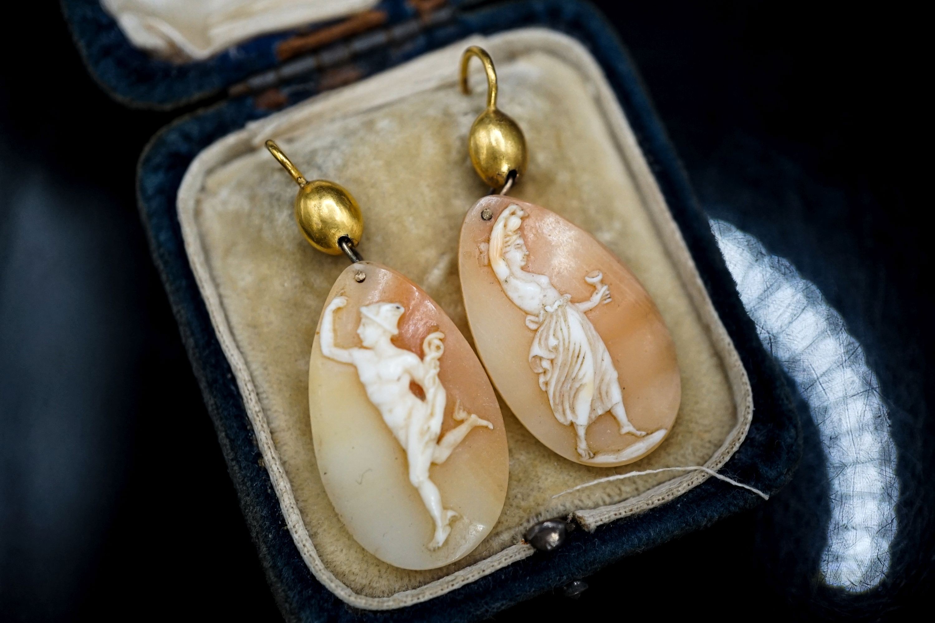 A pair of Victorian yellow metal and cameo shell ovoid earrings, carved with Mercury & Flora, shell 26mm.